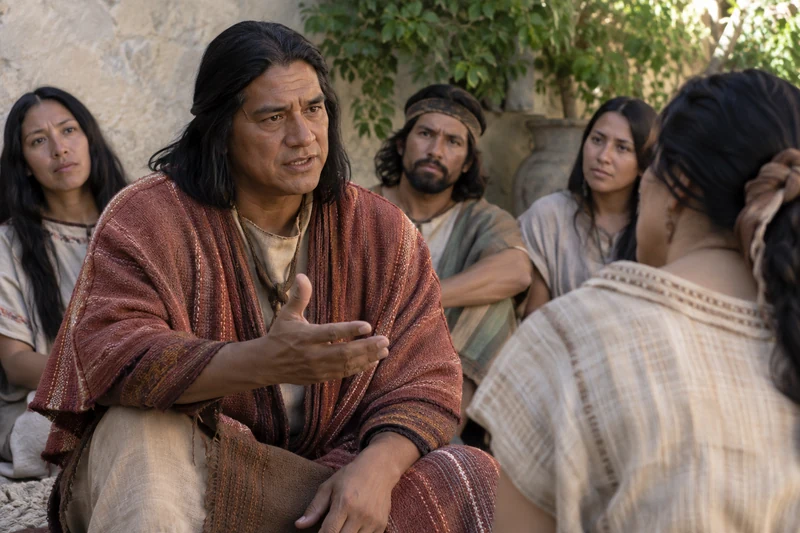 Alma speaks with a small group who listen closely to him.
