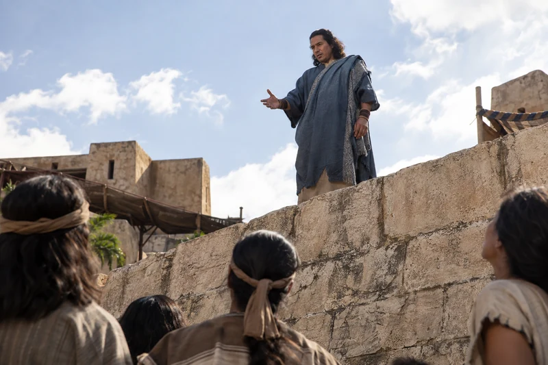 Samuel stands on the city wall and speaks to listeners below.