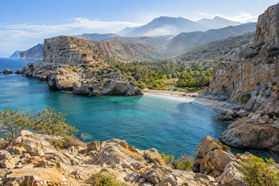 A green coastal inlet opens between rugged hills and quiet water.