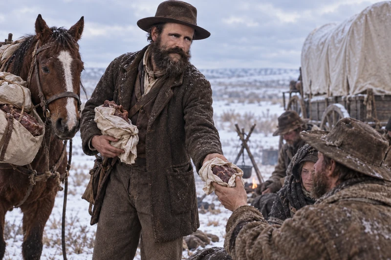 Ephraim Hanks offers buffalo meat to hungry emigrants beside his loaded horse.