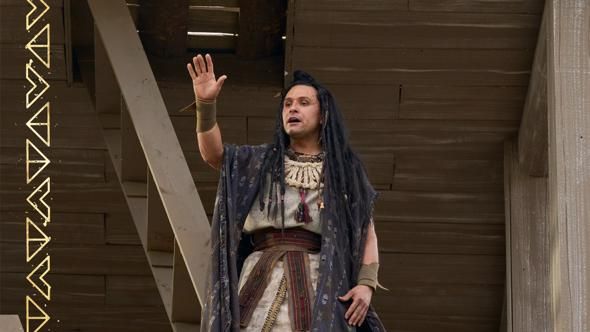 Samuel raises his hand while preaching from the city wall in the Book of Mormon video.